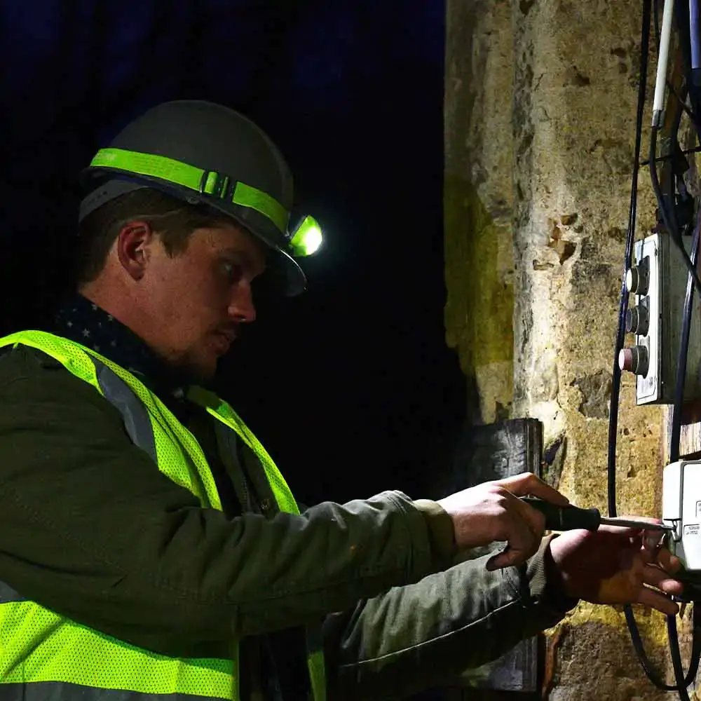 Vision-LED-Headlamp-being-used-by-worker-outside.webp