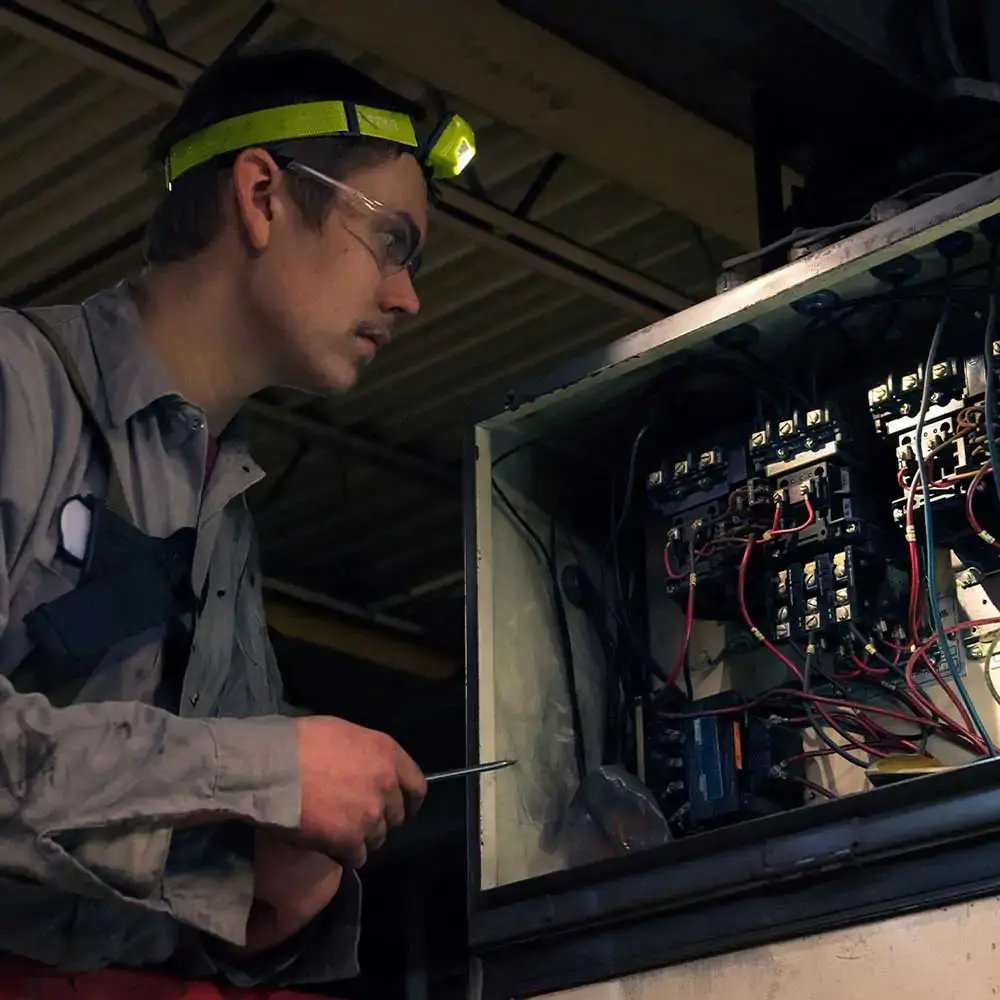 Vision-LED-Headlamp-being-used-by-worker.webp
